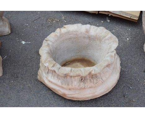 A large composite sack shaped planter