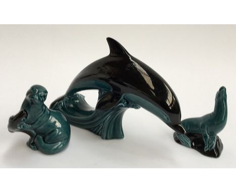 Three Poole Pottery animals; an otter, a seal, and a large dolphin