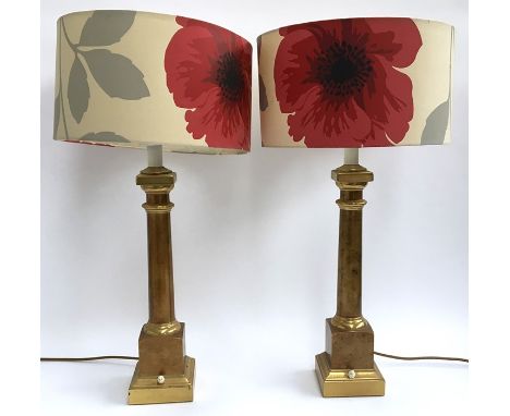 A pair of brass table lamps with poppy fabric lamp shades