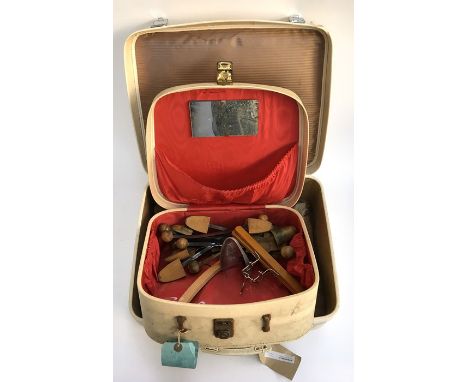 A box of vintage shoe trees, vanity case, and suitcase