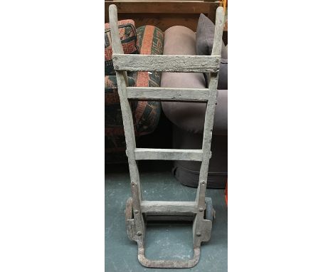 A vintage pine and cast iron sack trolley
