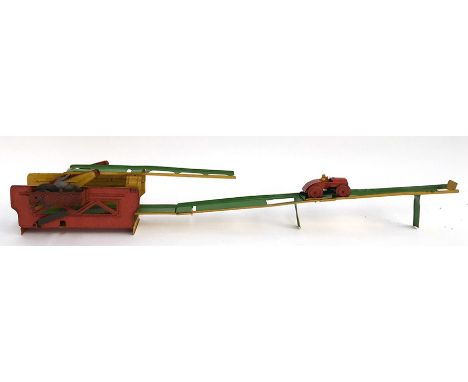A vintage 'perpetual motion' tin plate clockwork toy