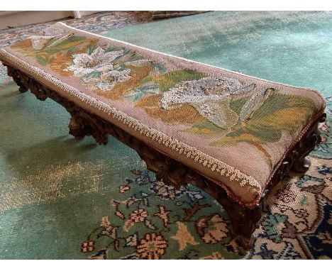 Victorian Gothic revival carved walnut long stool with original beadwork seat and carved masks, 108cm long