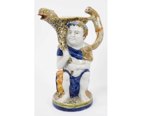 Prattware 'Bacchus &amp; Pan' jug, circa 1800, Bacchus shown seated on a barrel, with dolphin form spout and monkey handle, P