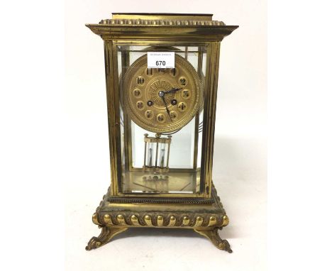 Early 20th century French four glass mantel clock with gilded mounts and dial, mercury adjusted pendulum on scroll feet 35.5c