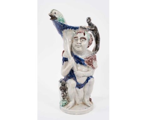 Prattware 'Bacchus &amp; Pan' jug, circa 1800, Bacchus shown seated on a barrel, with dolphin form spout and monkey handle, P