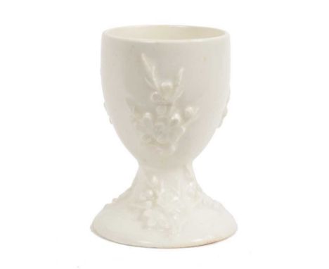 A rare Bow 'blanc de chine' egg cup, circa 1755, with sprigged prunus decoration, 7.75cm highCondition report: There is resto