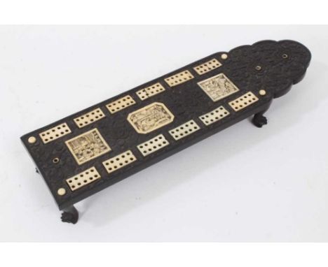 19th century Chinese black hardwood cribbage board, with carved floral decoration, inlaid ivory markers and carved plaques wi