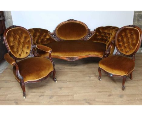 Matched suite of mid Victorian button upholstered walnut furniture to include camel back settee, open armchair and nursing ch