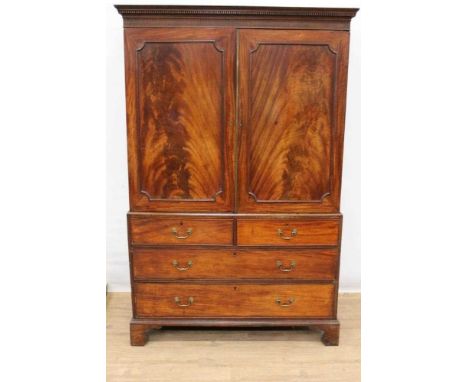 George III mahogany linen press, with dentil moulded cornice and fitted interior of short slides and hanging space enclosed b