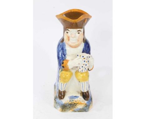 Prattware Toby jug, circa 1800, seated and holding frothing jug of beer, decorated in typical colours, with sponged base, bac