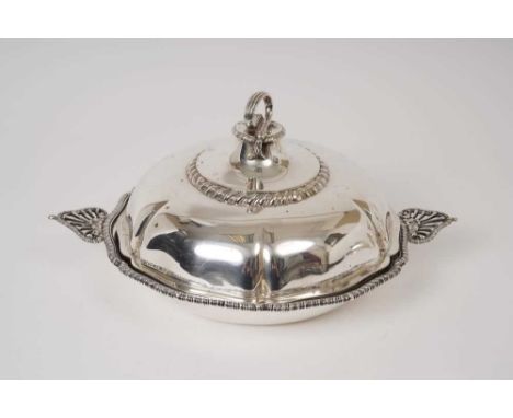 Edwardian silver entree dish of shaped hexagonal form, with gadrooned borders and pierced handles, matching domed cover, with