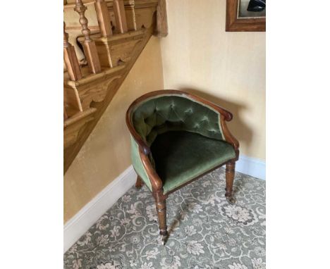 Early Victorian mahogany framed tub chair, with green button velvet upholstery on turned legs and castors