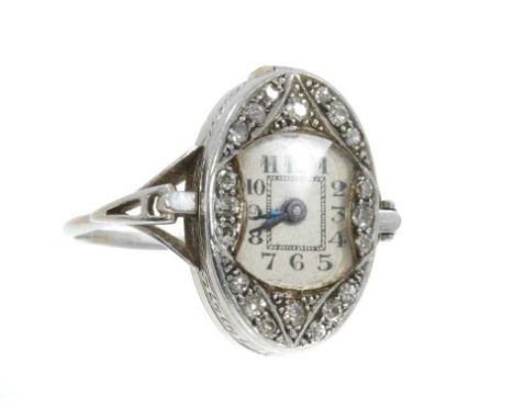 Rare Art Deco diamond and platinum watch ring, the oval case with single cut diamonds in platinum millegrain setting, the con