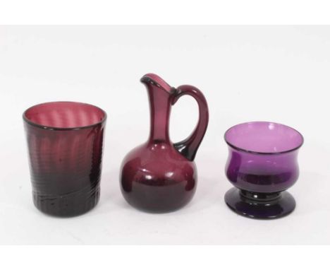 A 19th century amethyst tinted glass wrythen beaker, a small jug and a small baluster shaped bowl