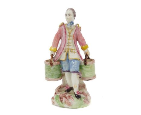 Rare 18th century Mennecy-Villeroy porcelain figure of a man holding two buckets, shown standing on a naturalistic base, wear