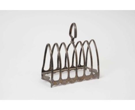 Fine quality 1920s silver six division toast rack of arched form, with central carrying handle, on four bracket feet (Sheffie