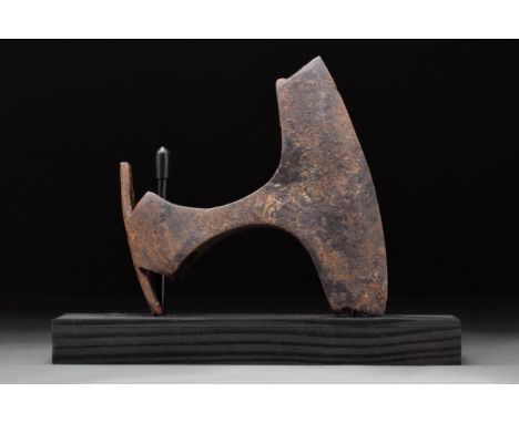 Circa 900-1000 AD. A hand-forged iron axe head with substantial curved blade and elliptical shaft-hole. The profile is square