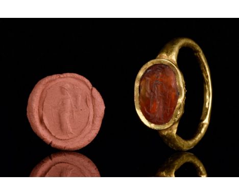 Circa 200-300 AD.The gold ring with oval-shaped carnelian intaglio engraved with a standing profile figure of Fortuna, her he