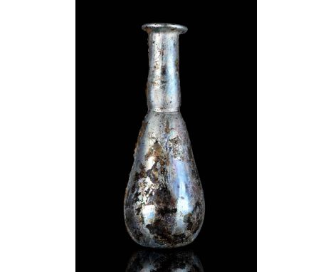 Circa 100 AD. A beautiful glass bottle with silver iridescence featuring a piriform body tapering to a long neck with flat fo