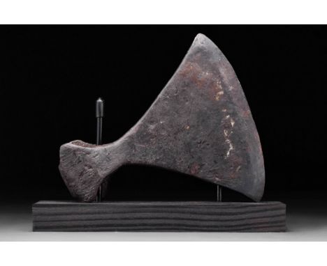 Circa 1000 - 1100 A.D. The broad blade flaring to the curved cutting edge, with eared socket with D-shaped aperture. Commonly