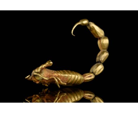 Circa 2000 BC. A beautifully decorated gold pendant in the form of scorpion with long curling tail and legs.The amulet or pen