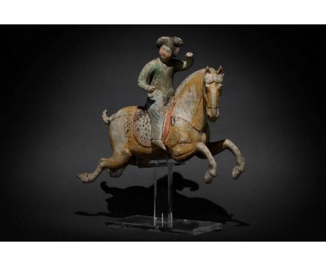 Tang Dynasty, Circa 618-906 AD A breath-takingly beautiful terracotta female polo rider with her head turned. She is depicted