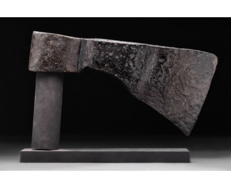 Circa 900 - 1000 AD. A forged-iron axe head of a hefty form with a perforated socketing shaft, a dense neck, and a vertically