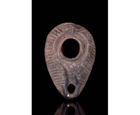 Circa 100-200 AD Ovoid in shape with sharp carination, angled ridge around wick-hole and fill-hole, the body decorated with a