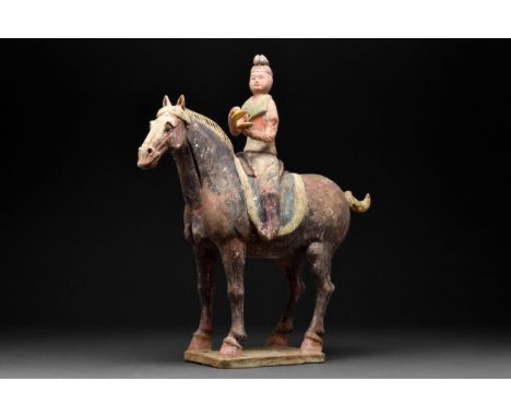 Tang Dynasty, Circa 618-906 AD. A beautiful hollow-moulded terracotta horse, modelled in a standing pose. An elegantly arched