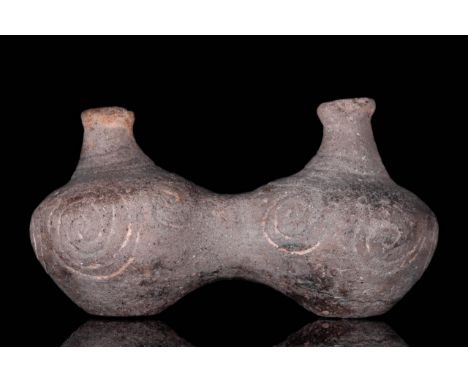 Circa 1550 - 1070 BC. A rare vessel in the form of two conjoined jars which are filled in and not hollow. These have decorate