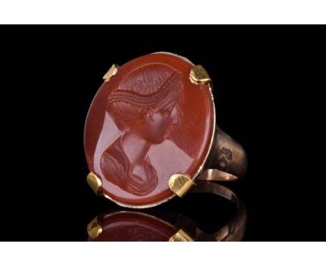 Circa 18th - 19th Century AD A gold ring with wide shank and oval-shaped bezel with carnelian intaglio depicting an Empress.S