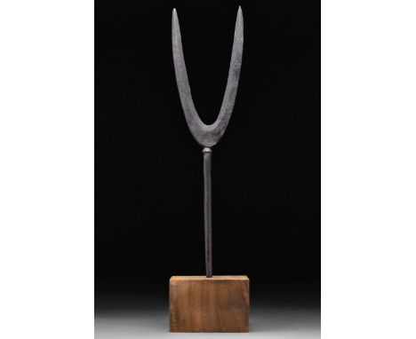 Circa 1000-1200 AD. A long iron hollow socked fork with long cylindrical handle with two dividing tapering ends forming the f