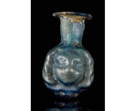 Circa 200-300 AD. The body mould-blown with two youthful faces with full cheeks, dimpled chins, and luxurious curly hair, wit