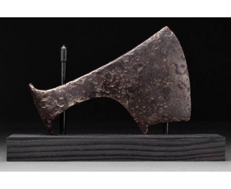 Circa 900 - 1000 AD A hand-forged iron axe head with substantial curved blade and elliptical shaft-hole. The profile is squar
