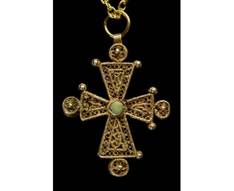 Circa 1200-1400 AD.This intricately formed cross is decorated with elaborate patterns in gold filigree, granulation, and wire