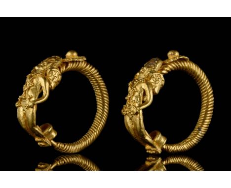 Circa 400-200 BC.A finely rendered matching pair of Greek Hellenistic gold earrings, each formed from a circular twisted wire