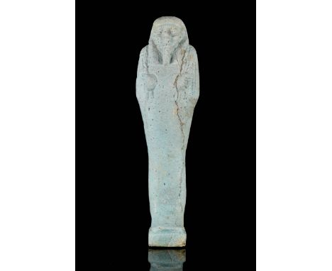 Late Period, circa 664-525 BC A mummiform ushabti in a light blue glazed faience, wearing a plain tripartite wig, and a divin