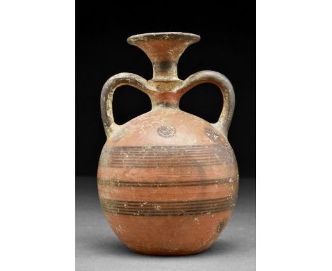 Cypro-Geometric III, circa 900 – 750 BC. A pottery flask in black on red with two twin handles, a funnel-like mouth, decorate