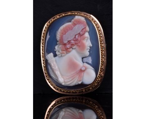 Circa 19th Century AD. This cameo brooch is beautifully crafted depicting the profile portrait of the sun god Apollo with str