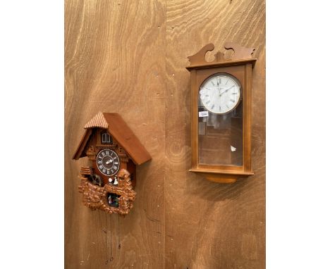 A WOODEN VIENNA STYLE WALL CLOCK AND A MODERN CUCKOO CLOCK 