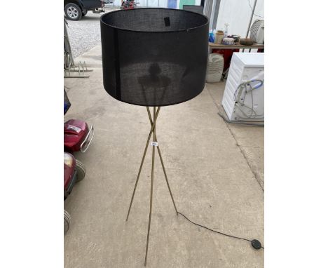 A GILT TRIPOD FLOOR LAMP COMPLETE WITH SHADE 