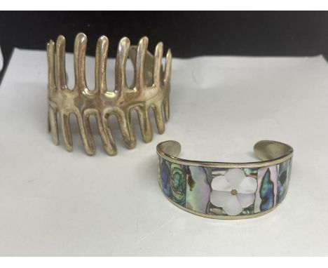 TWO SILVER BANGLES TO INCLUDE A MOTHER OF PEARL STYLE AND A FISHBONE DESIGN 