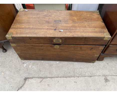 A 19TH CENTURY MAHOGANY TRUNK WITH MILITARY STYLE BRASS HANDLES AND STRAPS 