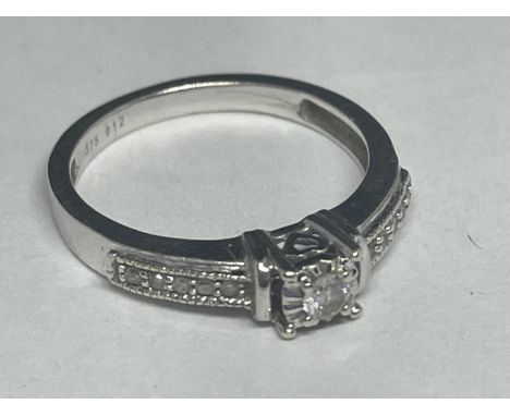 A 9 CARAT WHITE GOLD RING WITH CENTRE DIAMOND AND ON SHOULDERS SIZE K/L 