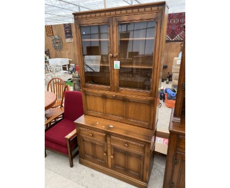 AN ERCOL COCKTAIL CABINET/BUREAU WITH GLAZED UPPER PORTION, 38.5" WIDE 