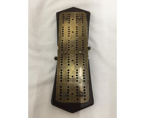 A VINTAGE BRASS CRIBBAGE BOARD 