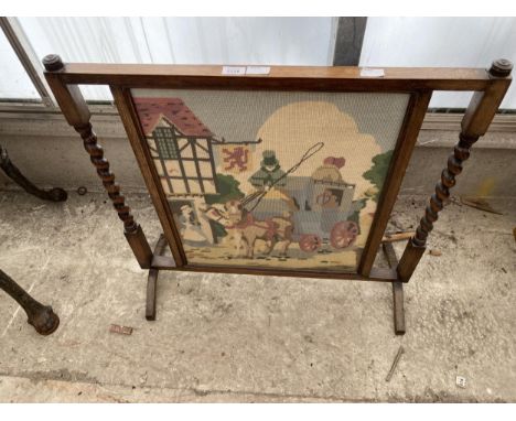 AN EARLY 20TH CENTURY OAK WOOLWORK FIRESCREEN WITH BARLEYTWIST UPRIGHTS, 30" WIDE 