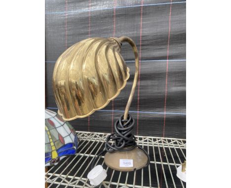 AN ADJUSTABLE LAMP WITH BRASS SHELL STYLE SHADE 