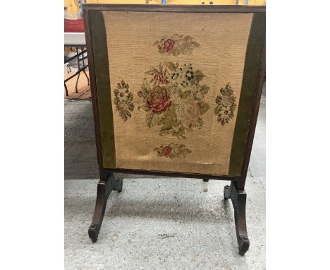 A TAPESTRY FIRESCREEN WITH SLIDE OUT PANELS AND AN OAK SURROUND 